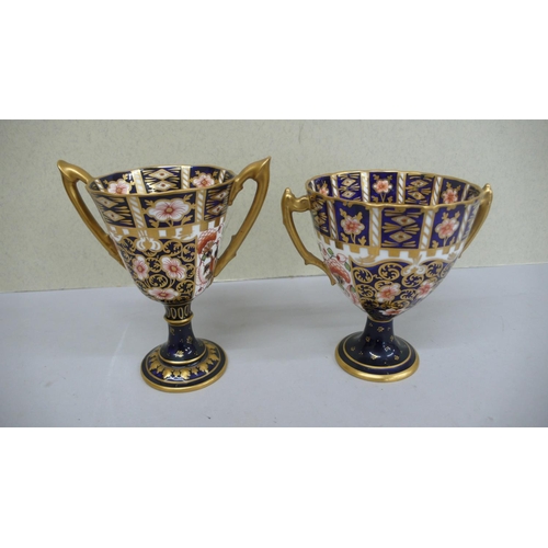 102 - Two Royal Crown Derby porcelain Imari pattern two handled goblets - 1909 & 1911 - Ht. 5 ins