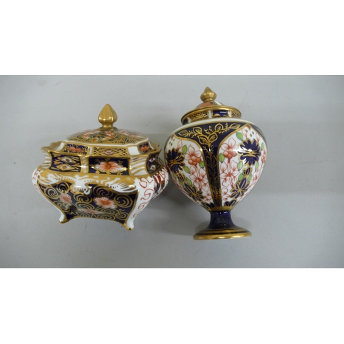 105 - Two Royal Crown Derby Imari pattern urns with finials - tallest 4.5 ins - 1920 & 1939