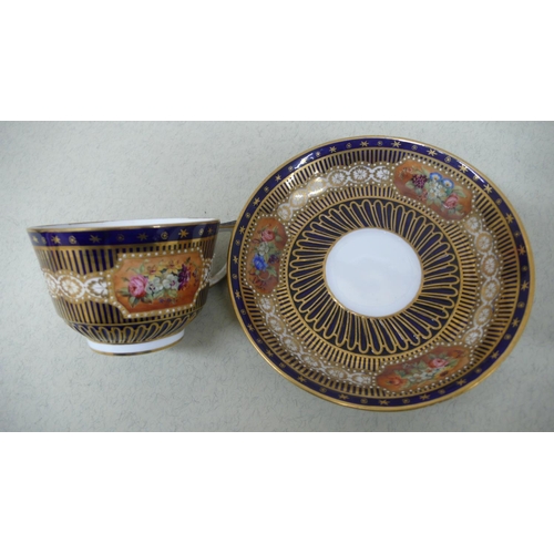 110 - Royal Crown Derby cabinet cup and saucer with five panels of hand painted flowers, gilt high lights ... 