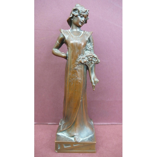 124 - Art Nouveau bronze figure of a girl standing holding flowers - Ht. 6.5 ins