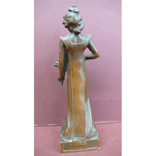 124 - Art Nouveau bronze figure of a girl standing holding flowers - Ht. 6.5 ins