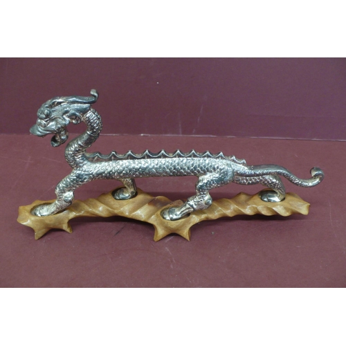 145 - Chinese silver plated metal dragon on purpose built hardwood stand - length 13 ins