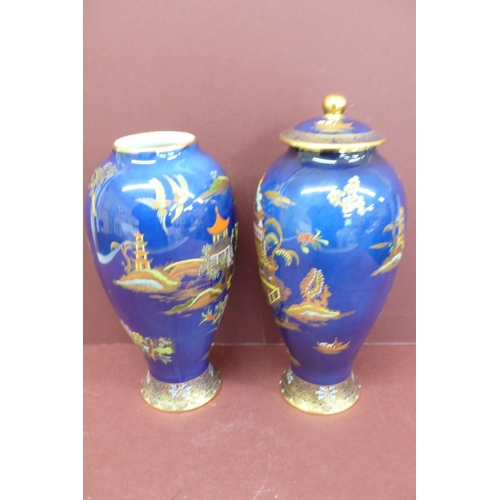 147 - Pair of Carlton ware baluster shaped pottery vases with chinoiserie decoration on a dark blue ground... 