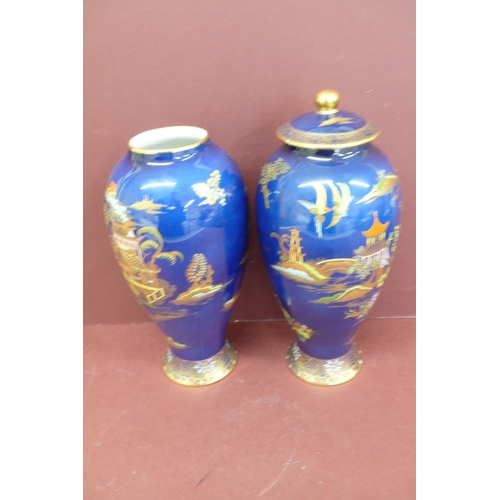 147 - Pair of Carlton ware baluster shaped pottery vases with chinoiserie decoration on a dark blue ground... 