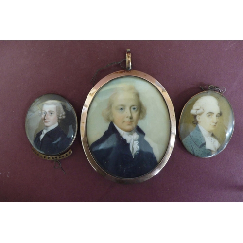 163 - Three well painted Georgian oval miniatures of men set in gold frames - largest ht. 2.6 ins