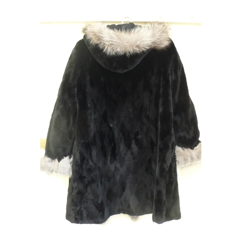 211 - Ladies reversible shower proof cropped black mink mid length coat with hood having silver fox fur tr... 