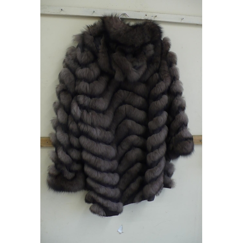 217 - Ladies reversible shower proof brown fox fur coat in a chevron pattern size 12/14 with hood