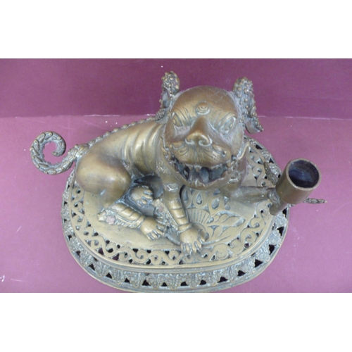 220 - 19thC Oriental brass lion dog holding a torch on a pedastal height 8.5, width 10.5ins