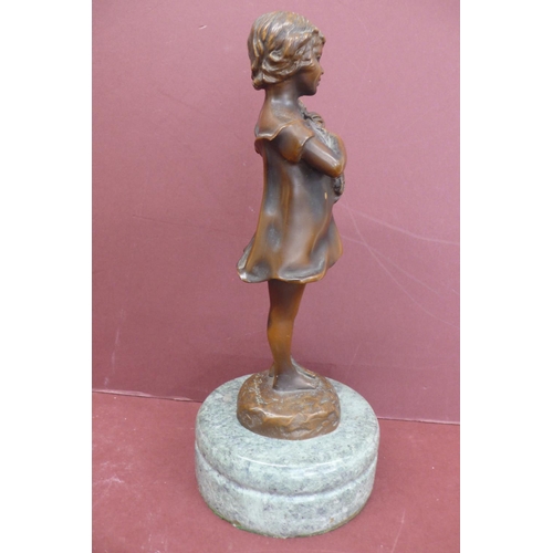 228 - S. Buzard? 20thC young girl holding firewood, brown patinated bronze on a green marble base signed, ... 