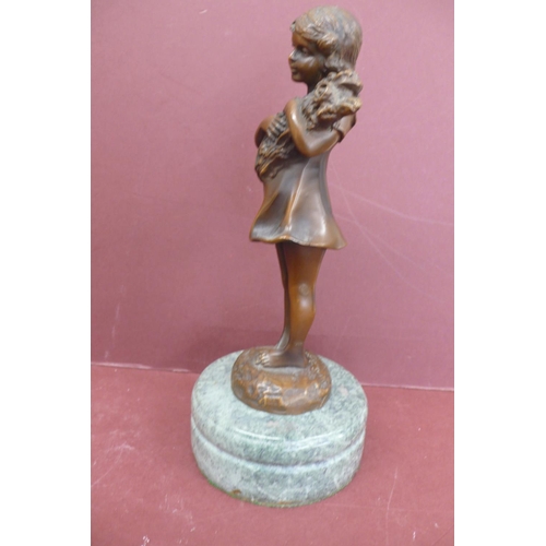 228 - S. Buzard? 20thC young girl holding firewood, brown patinated bronze on a green marble base signed, ... 