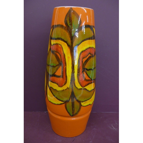 229 - Large Poole cylindrical pottery vase, orange, yellow, red, green and black abstract design on an ora... 