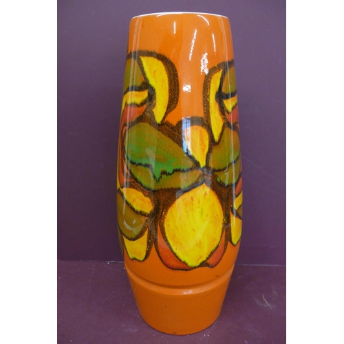 229 - Large Poole cylindrical pottery vase, orange, yellow, red, green and black abstract design on an ora... 