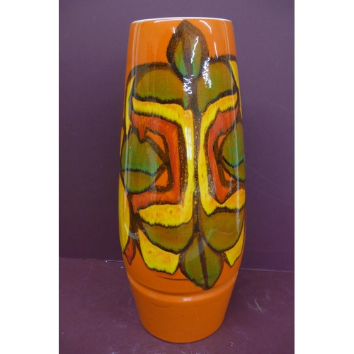 229 - Large Poole cylindrical pottery vase, orange, yellow, red, green and black abstract design on an ora... 