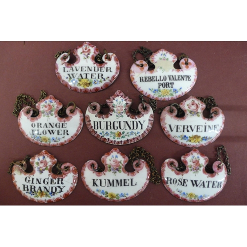 230 - A Collection of eight 19th/20thC enamel decanter labels with floral decoration