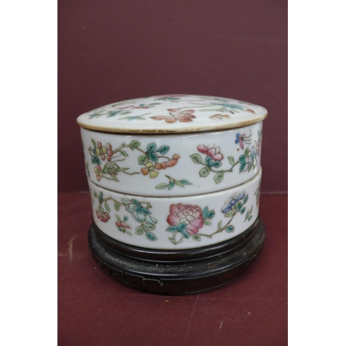 233 - 19thC Chinese porcelain two section circular box with cover having decoration of flowers and insects... 