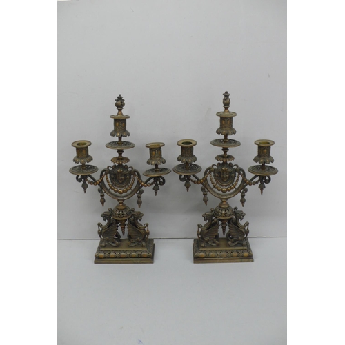 240 - Pair of late Victorian ornate brass three branch candelabra with flaming torch finial, decoration of... 