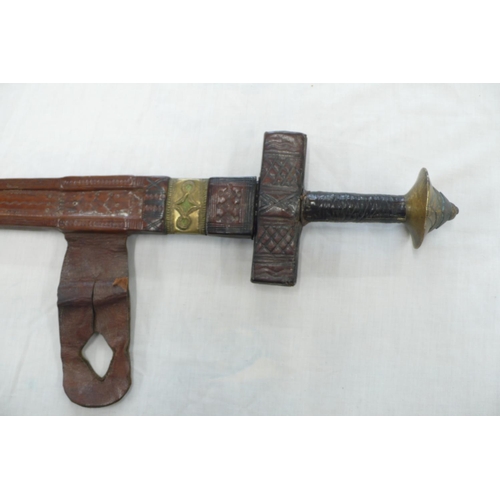 248 - Late 19thC African double edged blade sword with brass pommel in a leather scabbard with brass fitti... 