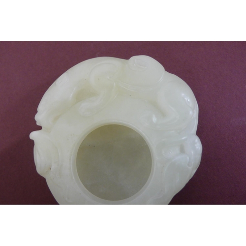 260 - A small Chinese pale green jade brush water pot with winged lion and cub to border - width 2ins , he... 