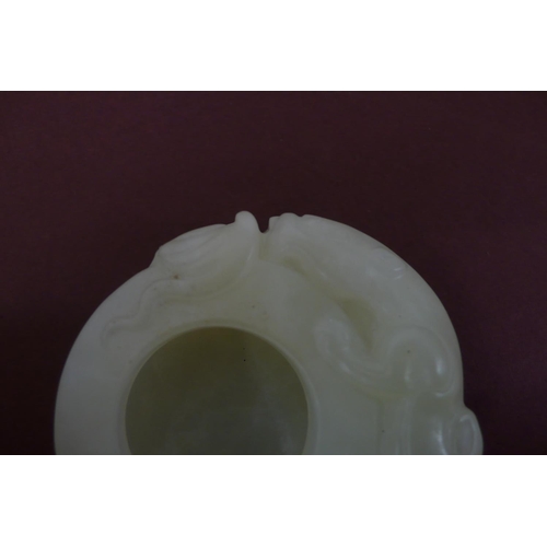 260 - A small Chinese pale green jade brush water pot with winged lion and cub to border - width 2ins , he... 