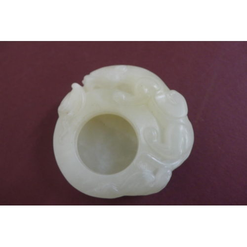 260 - A small Chinese pale green jade brush water pot with winged lion and cub to border - width 2ins , he... 