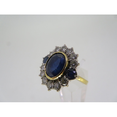 294 - An oval sapphire and diamond cluster ring 2.5 ct. sapphire and 1.2 cts. of diamonds set in gold - si... 