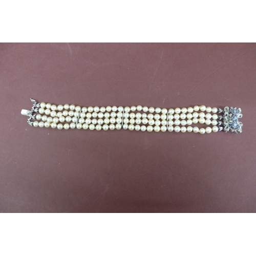 302 - Quadruple cultured pearl bracelet with 18ct white gold and sapphire clasp - length 7.5ins