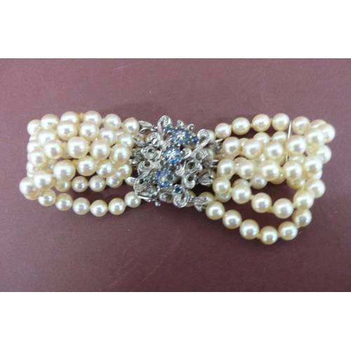 302 - Quadruple cultured pearl bracelet with 18ct white gold and sapphire clasp - length 7.5ins