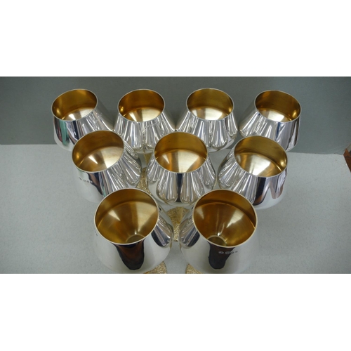 68 - A set of nine Stuart Devlin Parcel Gilt Silver red wine goblets with inverted conical bowls, reeded ... 