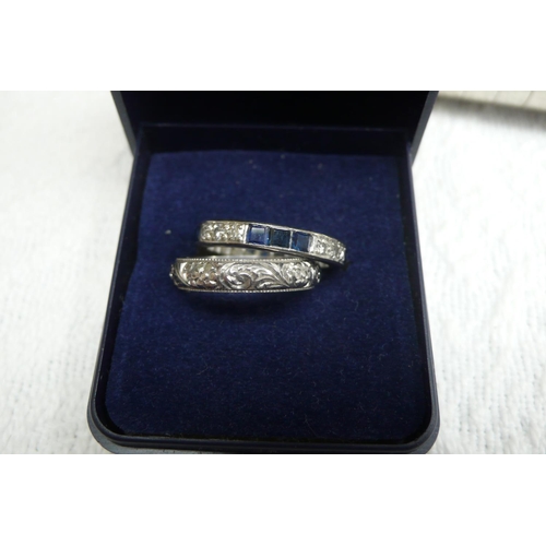 379 - Platinum sapphire and diamond eternity ring together with 18 ct. white gold wedding band - both size... 