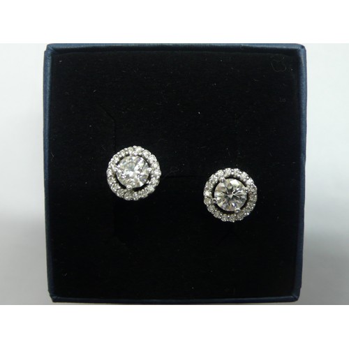 381 - Pair of brilliant cut diamond ear studs surrounded by sixteen smaller diamonds set in white gold, ea... 