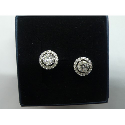 381 - Pair of brilliant cut diamond ear studs surrounded by sixteen smaller diamonds set in white gold, ea... 