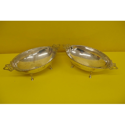 16 - Pair of pretty Edwardian Silver oval bonbon bowls with ribbon decoration handles on four hoof feet, ... 