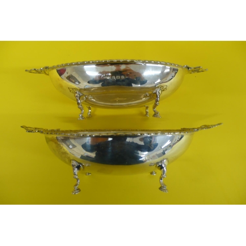 16 - Pair of pretty Edwardian Silver oval bonbon bowls with ribbon decoration handles on four hoof feet, ... 