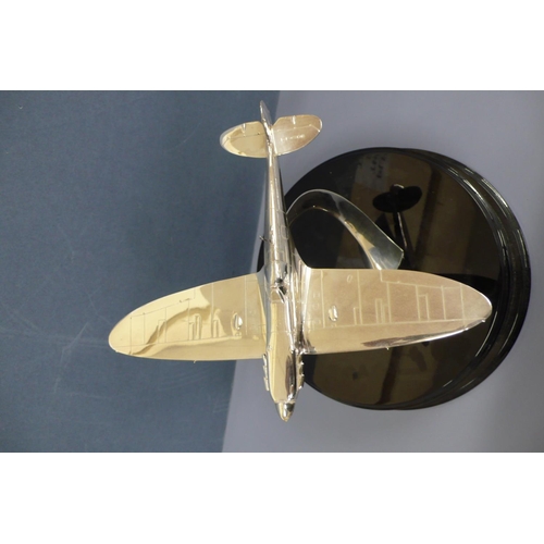 38 - A silver model of a spitfire in flight. Mounted on a black enamel circular plaque diameter 10ins, Wi... 