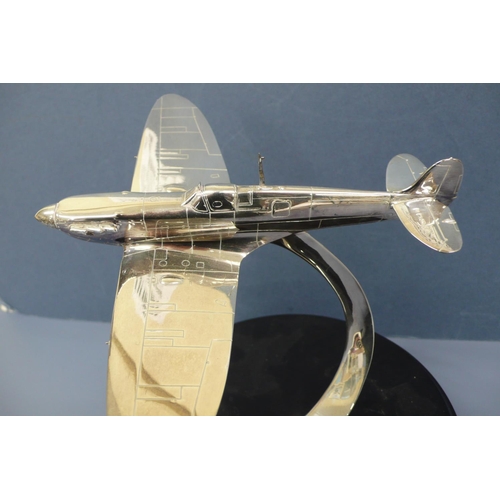 38 - A silver model of a spitfire in flight. Mounted on a black enamel circular plaque diameter 10ins, Wi... 