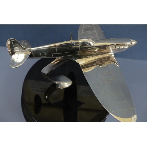 38 - A silver model of a spitfire in flight. Mounted on a black enamel circular plaque diameter 10ins, Wi... 