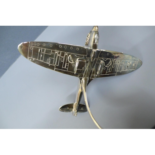 38 - A silver model of a spitfire in flight. Mounted on a black enamel circular plaque diameter 10ins, Wi... 