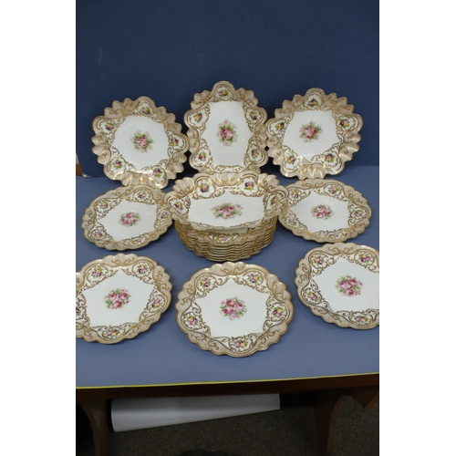 43 - A pretty sixteen piece crescent china fluted dessert service with painted gilt borders and decoratio... 