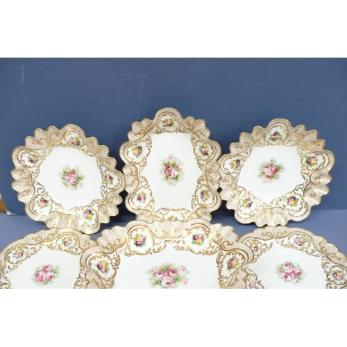 43 - A pretty sixteen piece crescent china fluted dessert service with painted gilt borders and decoratio... 