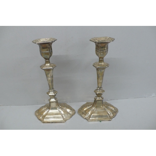 102 - Pair of Edwardian Oval fluted loaded silver candle sticks, London 1908, Height 11ins