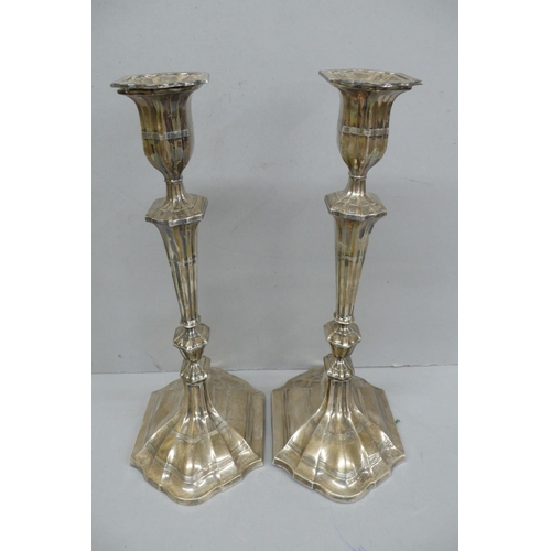 102 - Pair of Edwardian Oval fluted loaded silver candle sticks, London 1908, Height 11ins