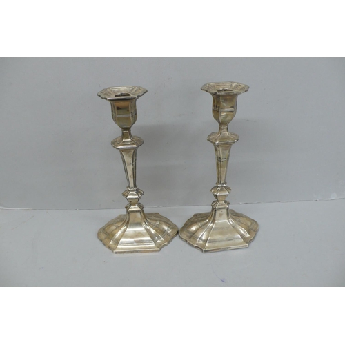 102 - Pair of Edwardian Oval fluted loaded silver candle sticks, London 1908, Height 11ins