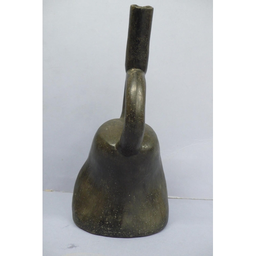 131 - An Early/Middle period blackware pottery Stirrup Vessel in the form of a mans head wearing a headdre... 