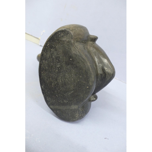 131 - An Early/Middle period blackware pottery Stirrup Vessel in the form of a mans head wearing a headdre... 