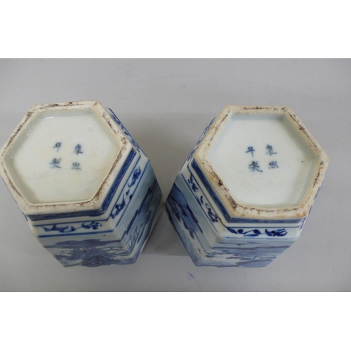 144 - Pair of 19th/20thC Chinese blue and white hexagonal vases with decoration of figure crossing a bridg... 