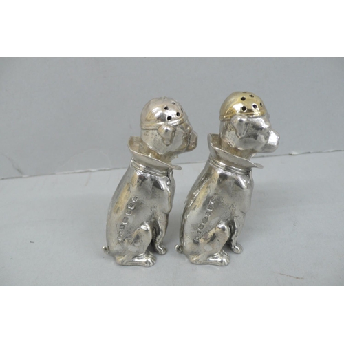 157 - Pair of Heavy Cast silver salt and pepper pots in the form of dogs wearing caps, collars and bow tie... 