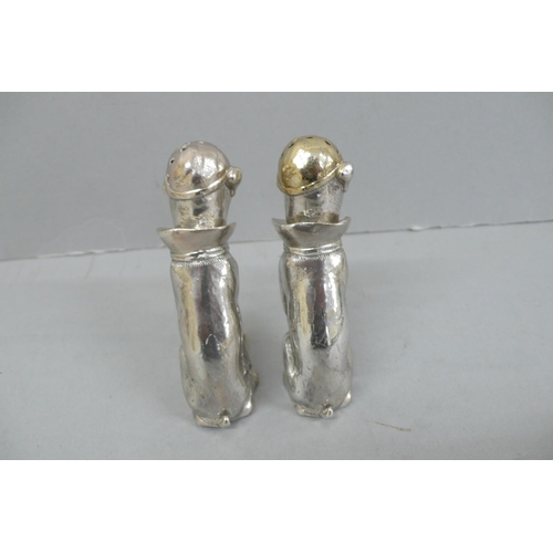 157 - Pair of Heavy Cast silver salt and pepper pots in the form of dogs wearing caps, collars and bow tie... 