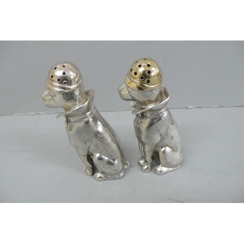 157 - Pair of Heavy Cast silver salt and pepper pots in the form of dogs wearing caps, collars and bow tie... 