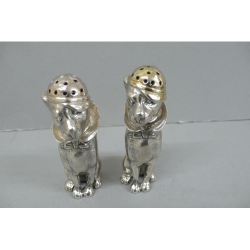 157 - Pair of Heavy Cast silver salt and pepper pots in the form of dogs wearing caps, collars and bow tie... 