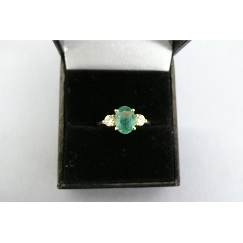 176 - An 18ct Gold oval emerald and diamond three stone ring (Emerald 1-26cts) Size N